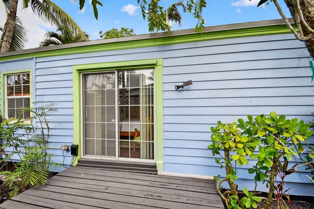 a spacious bedroom with a bed and wooden floor