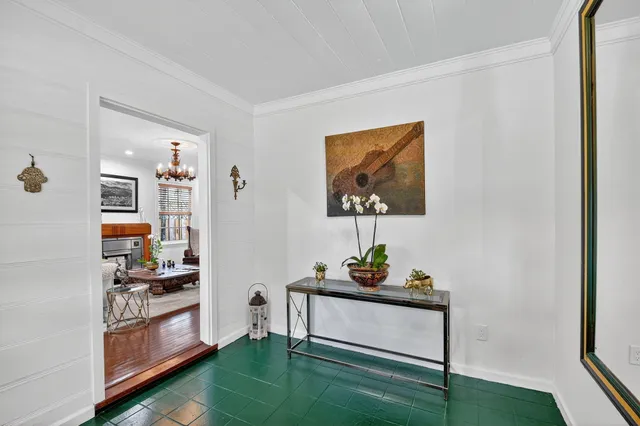 a living room with furniture and a kitchen view