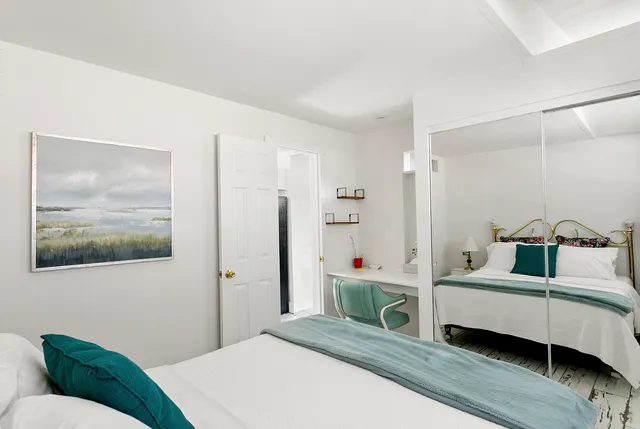 a kitchen with a refrigerator and white cabinets