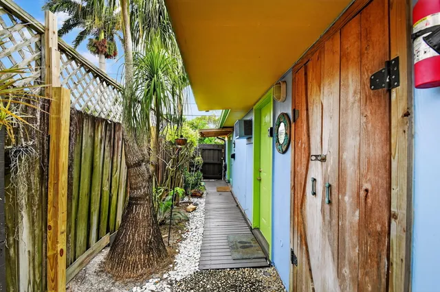 a view of a patio with table and chairs and wooden floor
