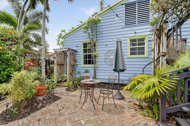 a large kitchen with a large counter top a sink a stove and a refrigerator