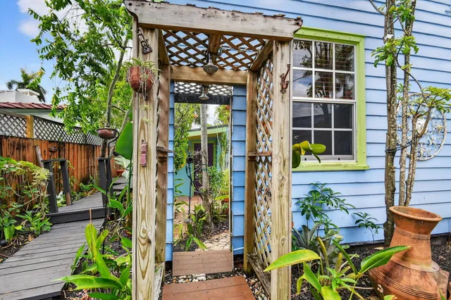 an aerial view of a house with a yard and large trees