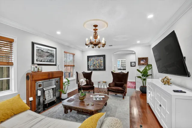 a living room with furniture a fireplace and a large window