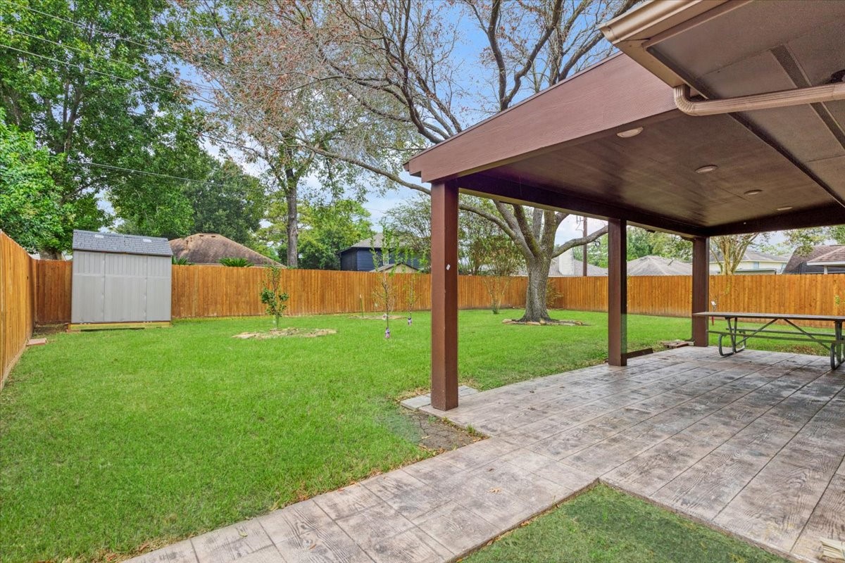 6123 Springhaven Drive Houston, TX 77396 - Photo 33 of 36 Enjoy outdoor dining or a quiet afternoon on the spacious covered patio overlooking the fenced backyard. The storage shed stays with the home.