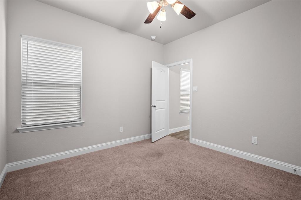 119 Happy Lane Red Oak, TX 75154 - Photo 28 of 37 Interior room featuring light gray walls, brown carpet flooring, and white trim