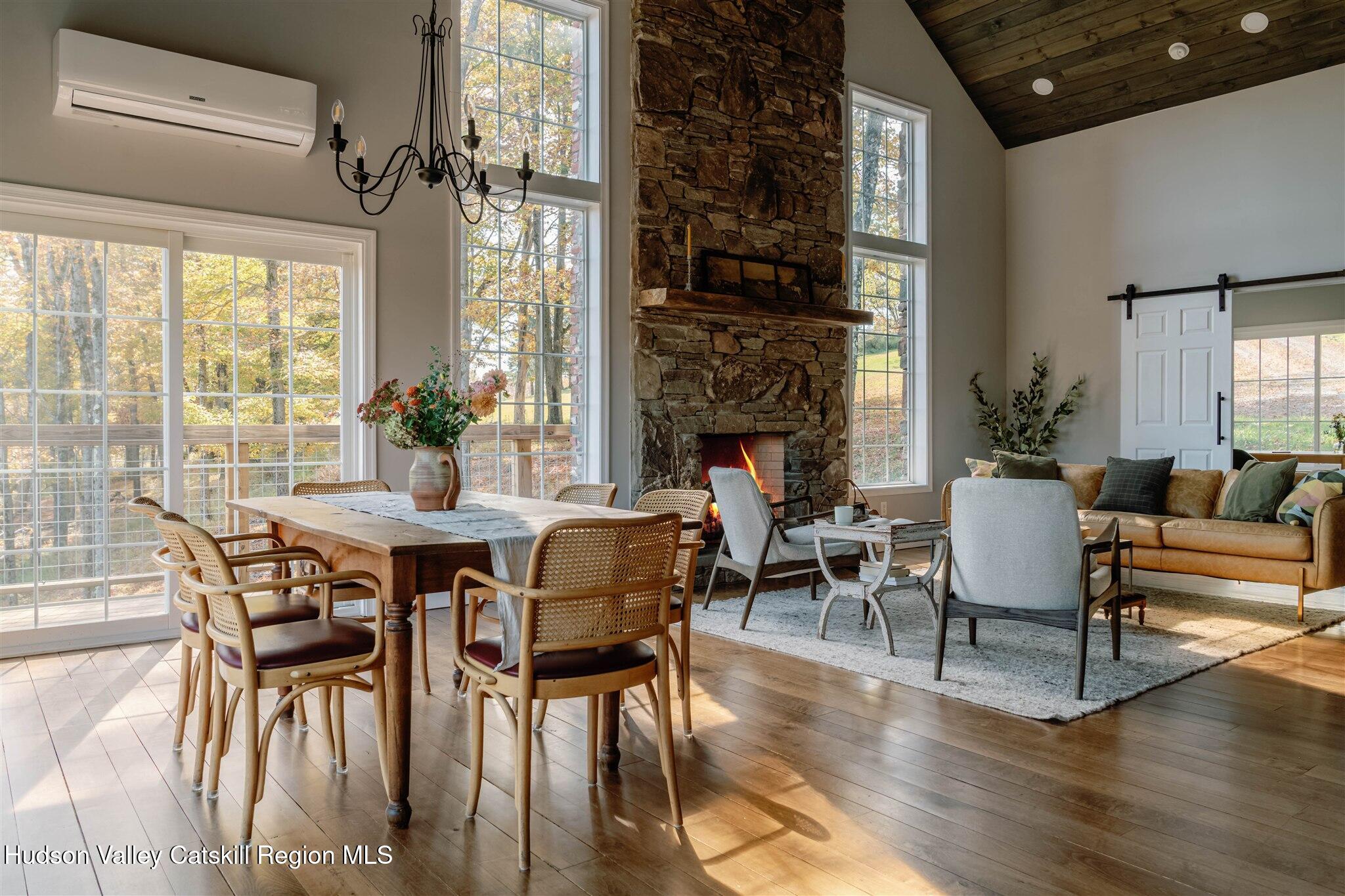 321 Mutton Hill Road Neversink, NY 12765 - Photo 12 of 25 a dining room with furniture a fireplace and wooden floor