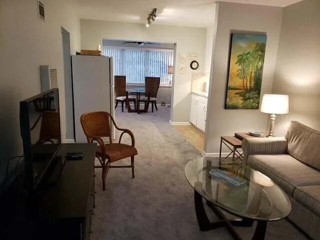 a living room with furniture and a lamp