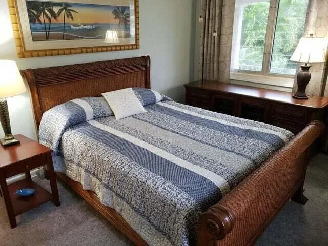 a bed sitting in a bedroom next to a window