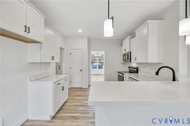 a view of an empty room and wooden floor