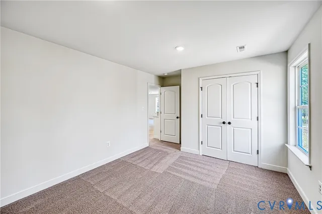 a bathroom with a granite countertop sink mirror vanity and toilet