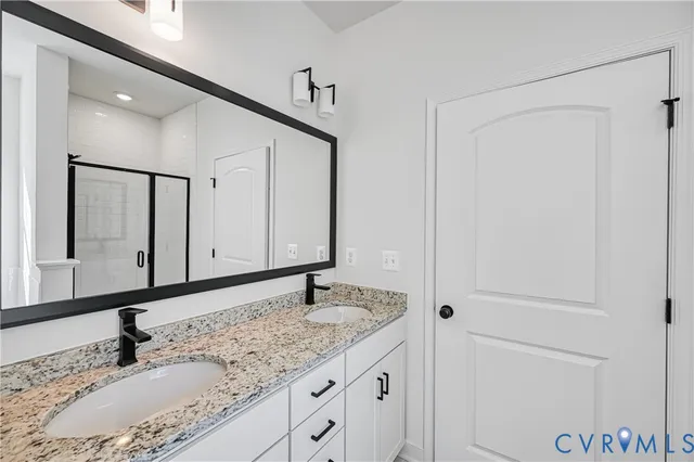 a bathroom with a granite countertop sink and a toilet