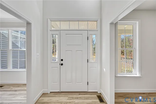 a view of a room with wooden floor and a window