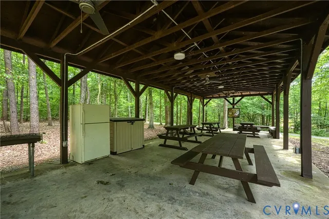 a view of backyard with swimming pool and seating space