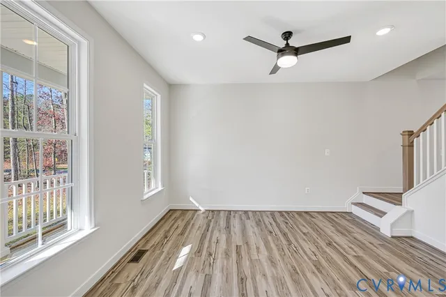 wooden floor in an empty room with a window