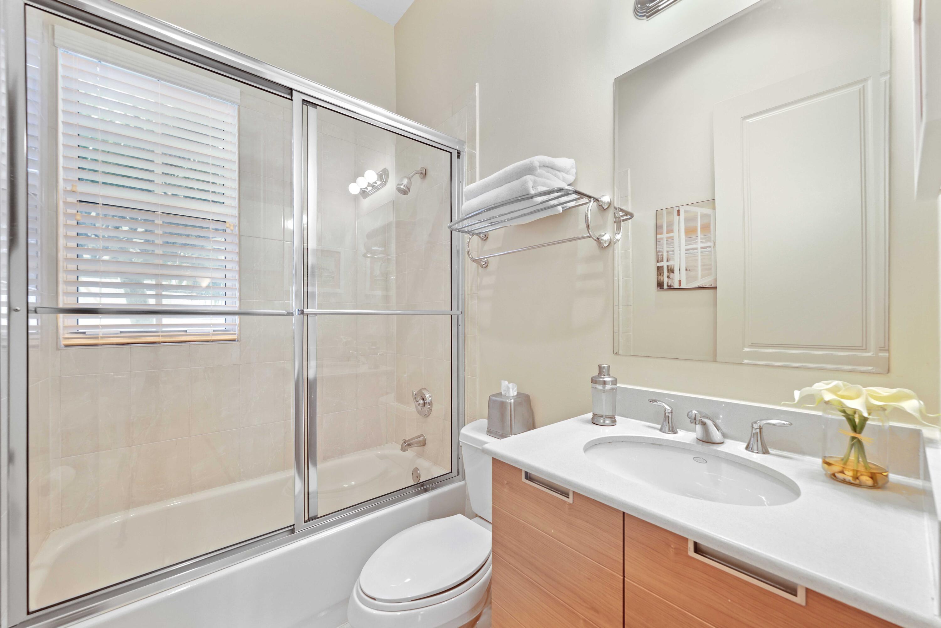 150 Northeast 6th Avenue, Unit K Delray Beach, FL 33483 - Photo 20 of 47 a bathroom with a sink a toilet and shower