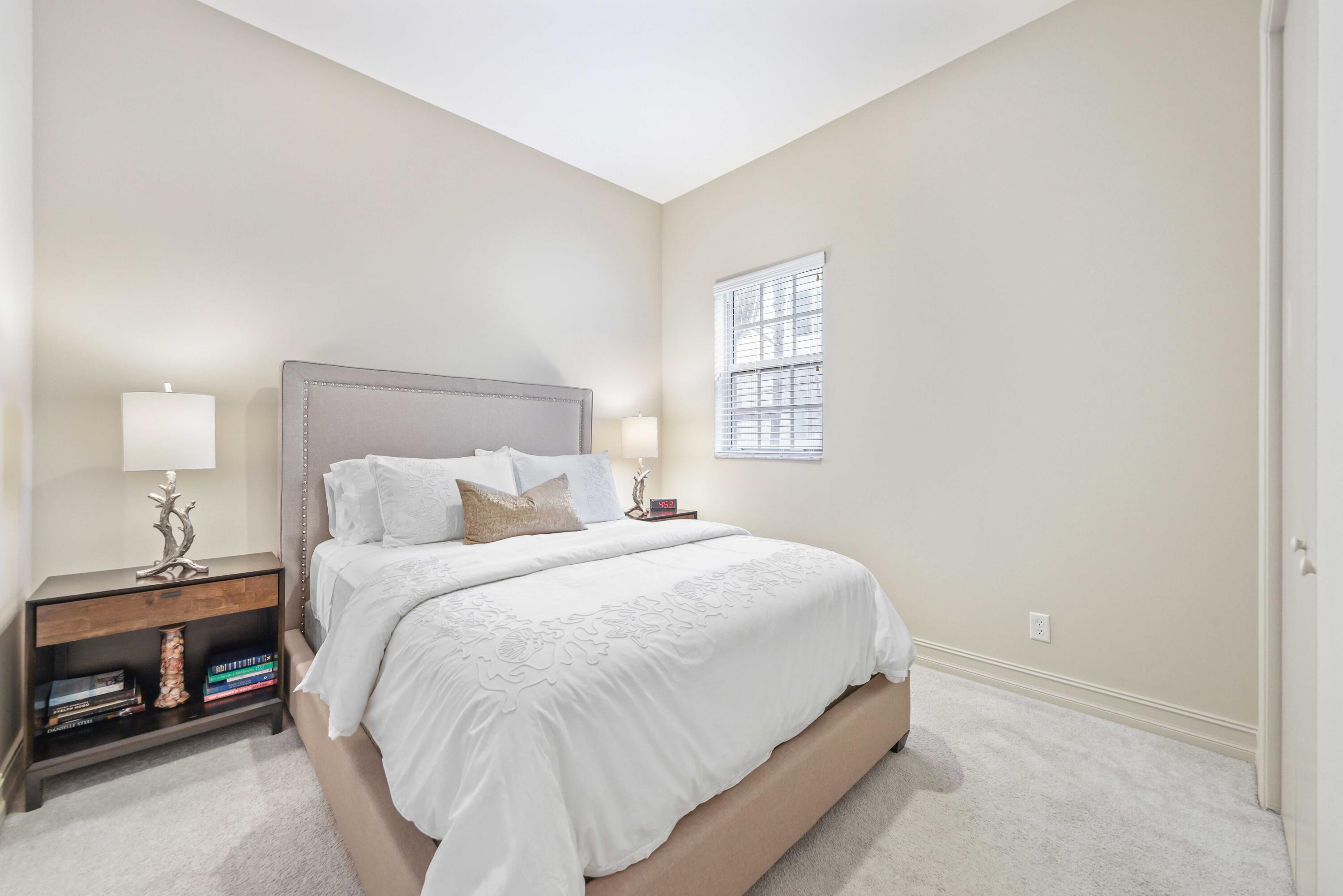 150 Northeast 6th Avenue, Unit K Delray Beach, FL 33483 - Photo 21 of 47 a bedroom with a bed and a window