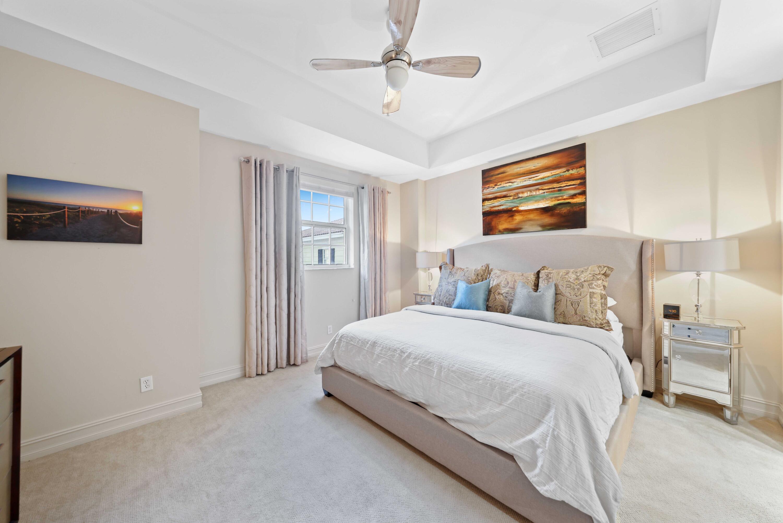 150 Northeast 6th Avenue, Unit K Delray Beach, FL 33483 - Photo 23 of 47 a spacious bedroom with a bed and a ceiling fan