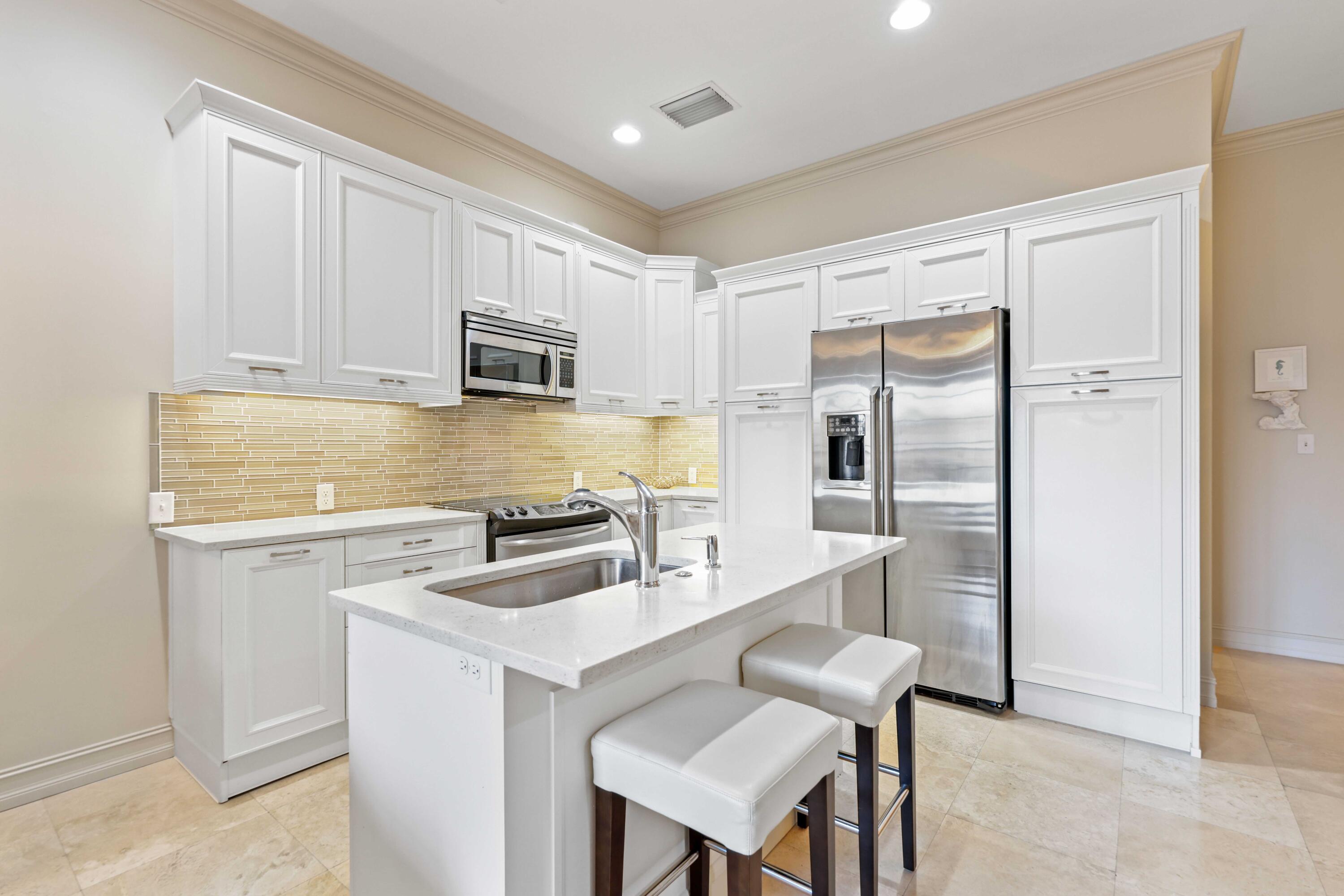 150 Northeast 6th Avenue, Unit K Delray Beach, FL 33483 - Photo 9 of 47 a kitchen with stainless steel appliances granite countertop a sink stove and refrigerator
