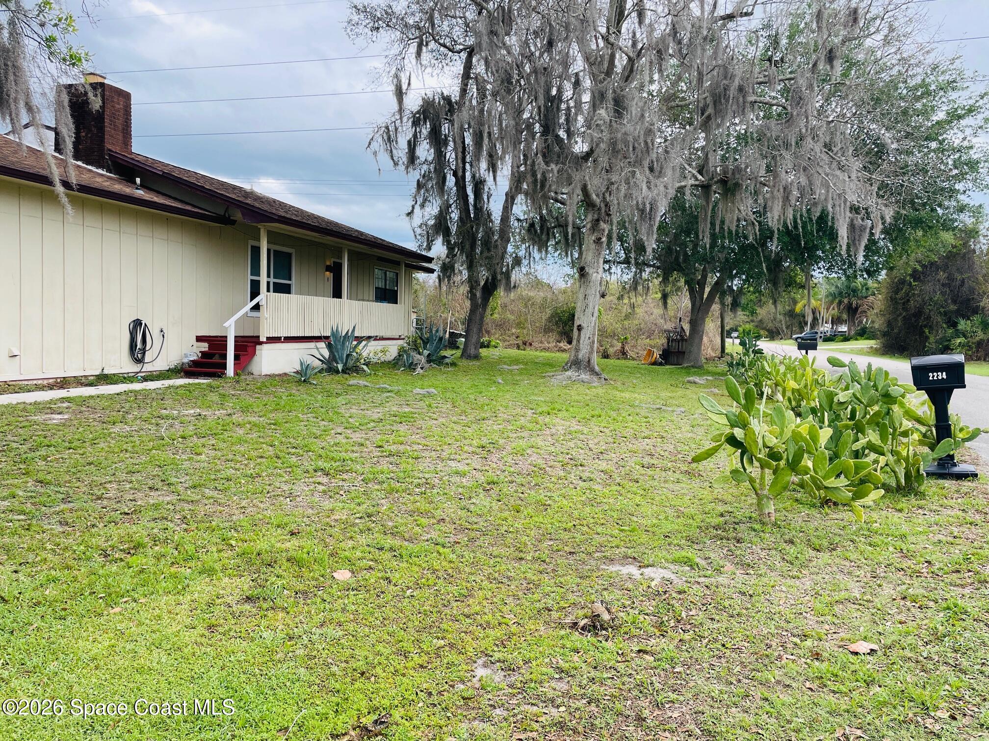 2235 Macedo Road Northeast Palm Bay, FL 32907 - Photo 2 of 23 Side yard