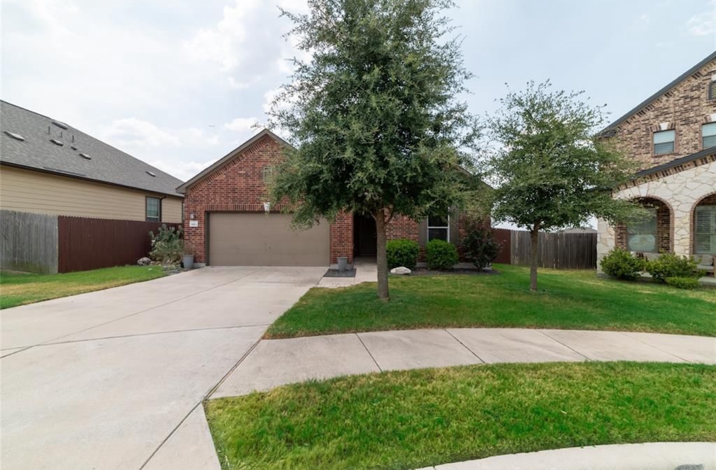 7013 Lickeen Court Austin, TX 78744 - Photo 1 of 20 a front view of a house with a yard and a garage