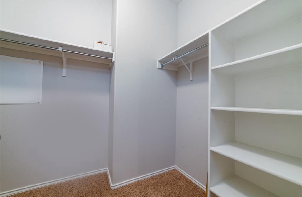 7013 Lickeen Court Austin, TX 78744 - Photo 9 of 20 a view of walk in closet with empty racks