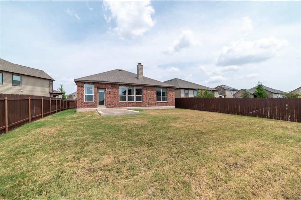 7013 Lickeen Court Austin, TX 78744 - Photo 14 of 20 a front view of a house with garden