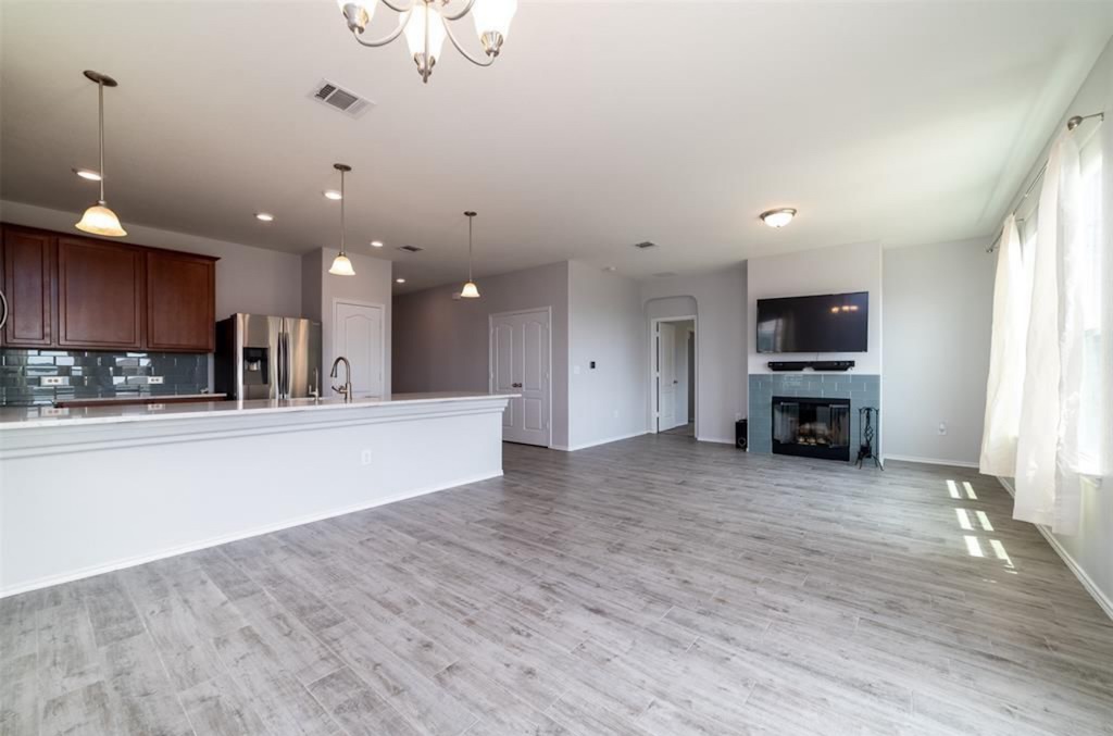 7013 Lickeen Court Austin, TX 78744 - Photo 20 of 20 a view of an empty room with kitchen and window