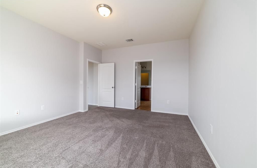 7013 Lickeen Court Austin, TX 78744 - Photo 6 of 20 a view of an empty room with wooden floor