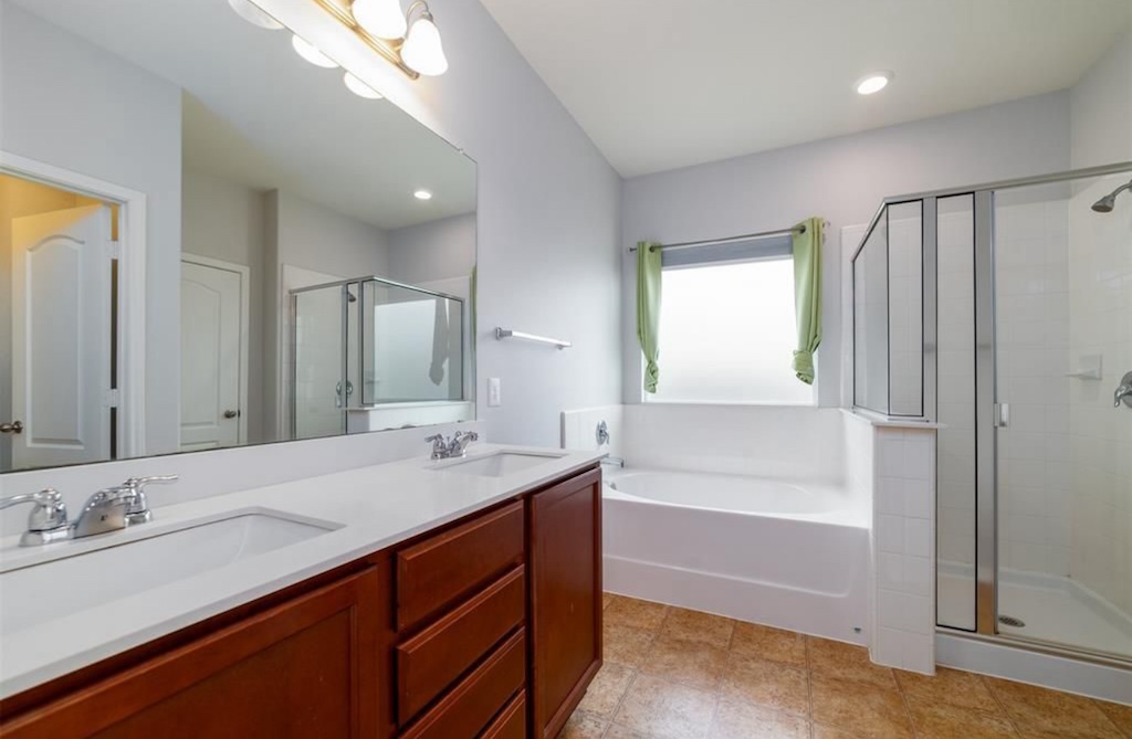 7013 Lickeen Court Austin, TX 78744 - Photo 7 of 20 a bathroom with a granite countertop sink mirror and a bath tub