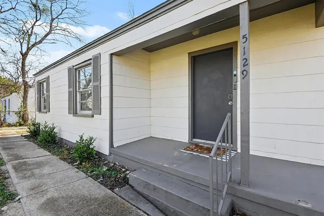 a view of a house with a small yard