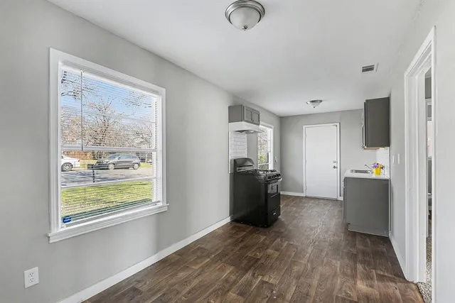 a view of kitchen with windows and refrigerator