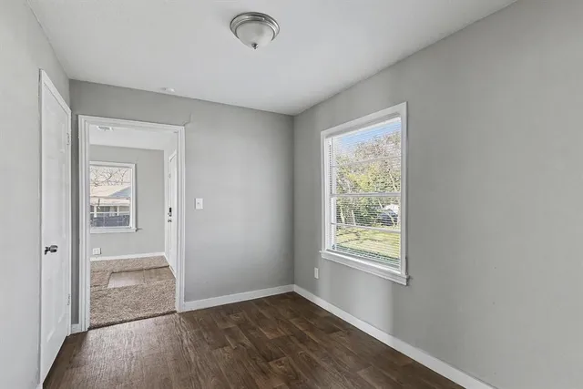 an empty room with windows and closet
