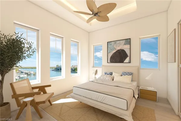 a bedroom with a bed and large windows