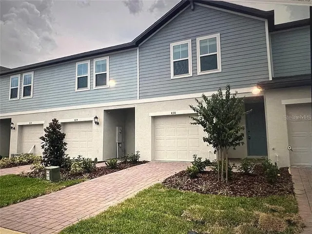 a front view of house with a garden