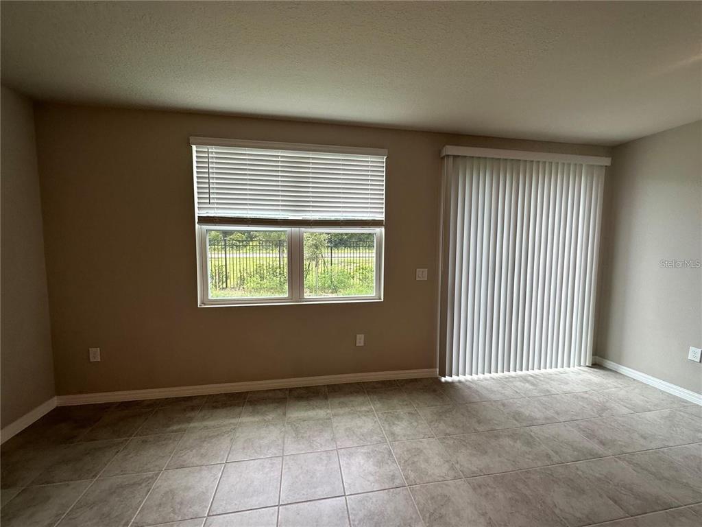 430 Legacy Loop Davenport, FL 33896 - Photo 11 of 21 a view of an empty room with a window