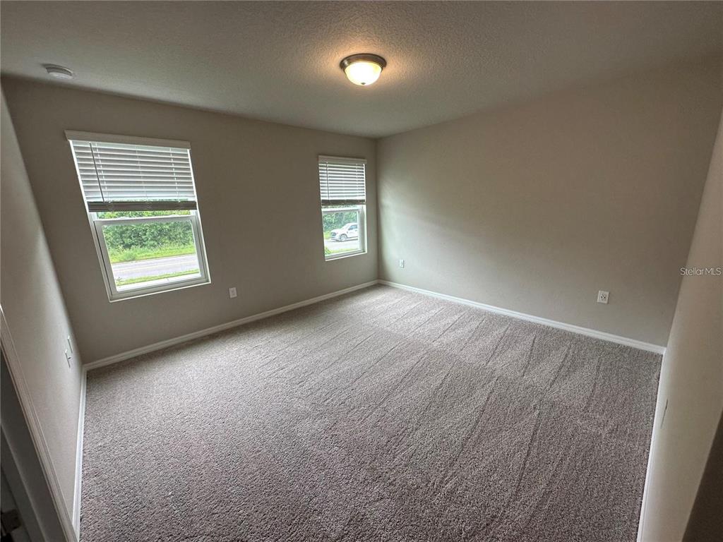 430 Legacy Loop Davenport, FL 33896 - Photo 17 of 21 an empty room with windows