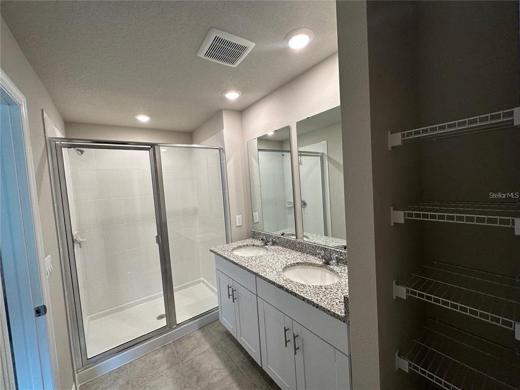 430 Legacy Loop Davenport, FL 33896 - Photo 18 of 21 a bathroom with double vanity and a shower