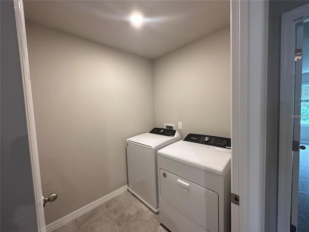 430 Legacy Loop Davenport, FL 33896 - Photo 20 of 21 a utility room with dryer and washer