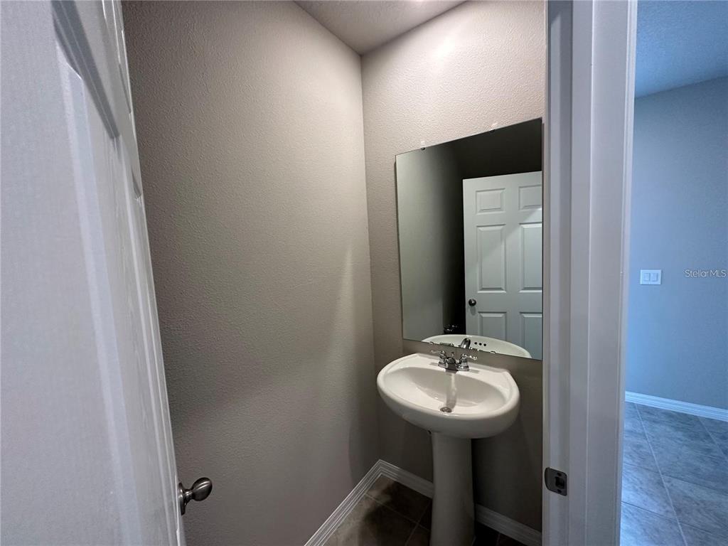 430 Legacy Loop Davenport, FL 33896 - Photo 3 of 21 a bathroom with a sink and a mirror