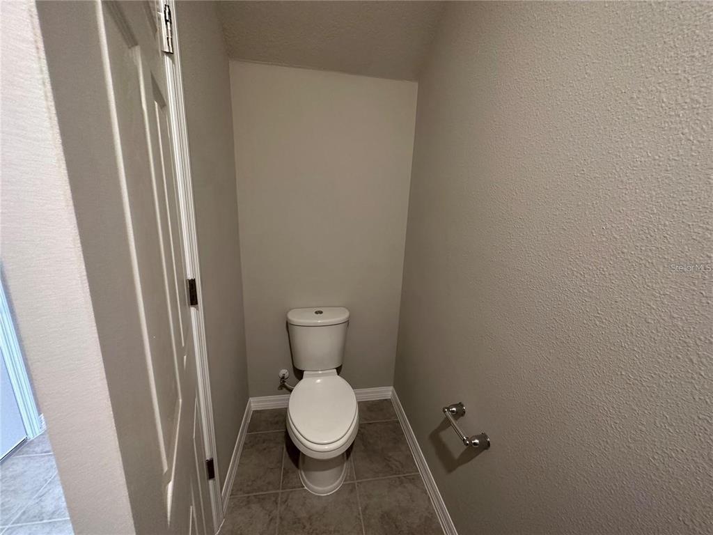 430 Legacy Loop Davenport, FL 33896 - Photo 4 of 21 a bathroom with a toilet and a sink