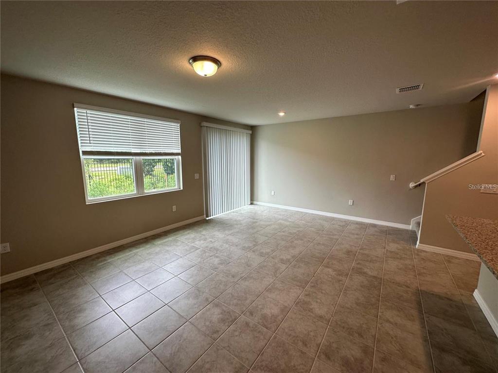 430 Legacy Loop Davenport, FL 33896 - Photo 9 of 21 a view of an empty room with a window