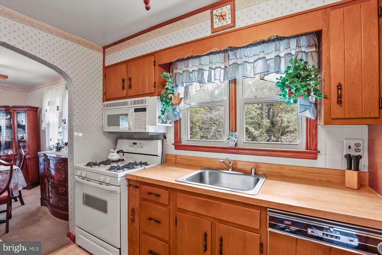 4817 East Joppa Road Perry Hall, MD 21128 - Photo 9 of 36 a kitchen that has a sink a stove and a microwave