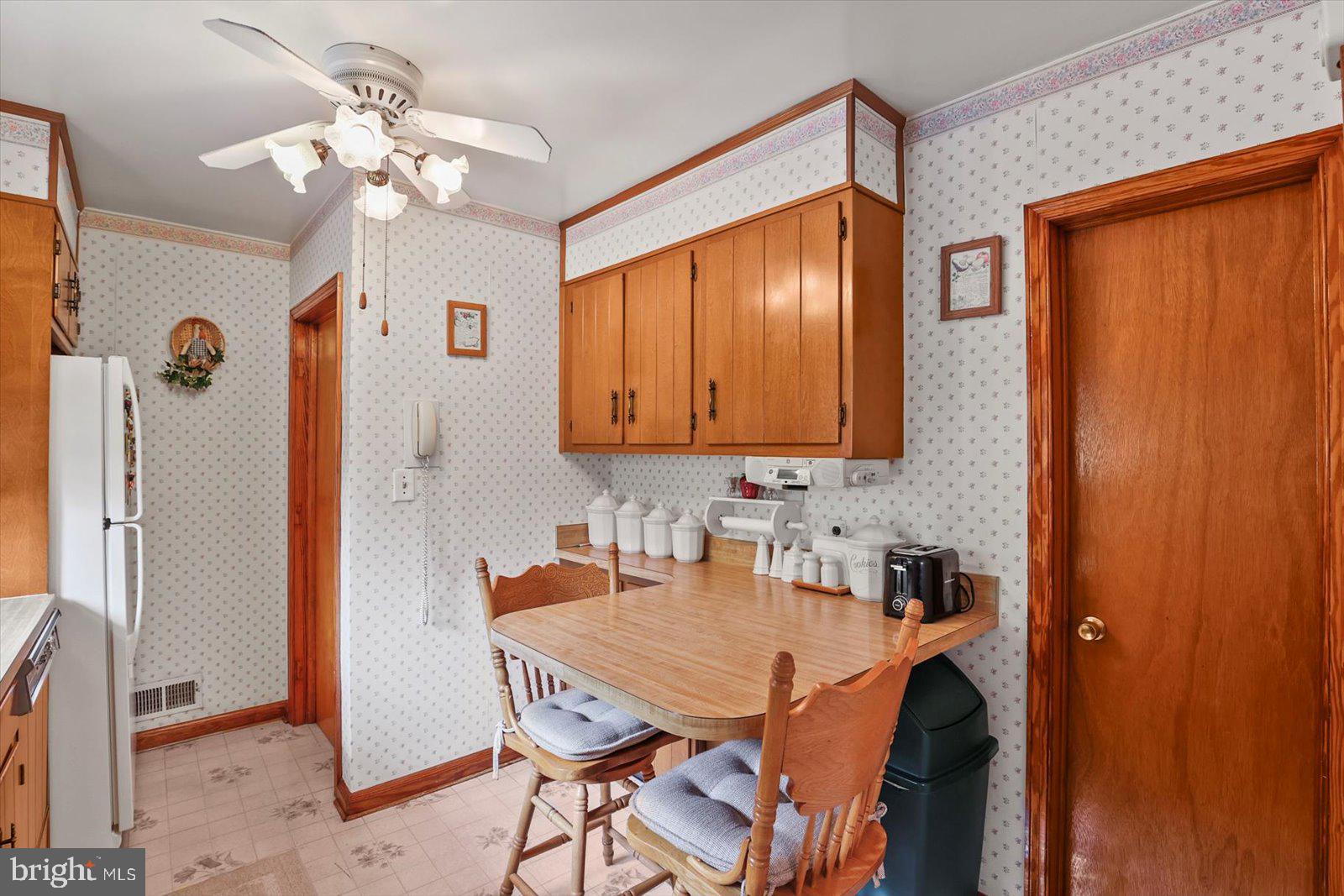 4817 East Joppa Road Perry Hall, MD 21128 - Photo 10 of 36 a dining room with stainless steel appliances a table and chairs