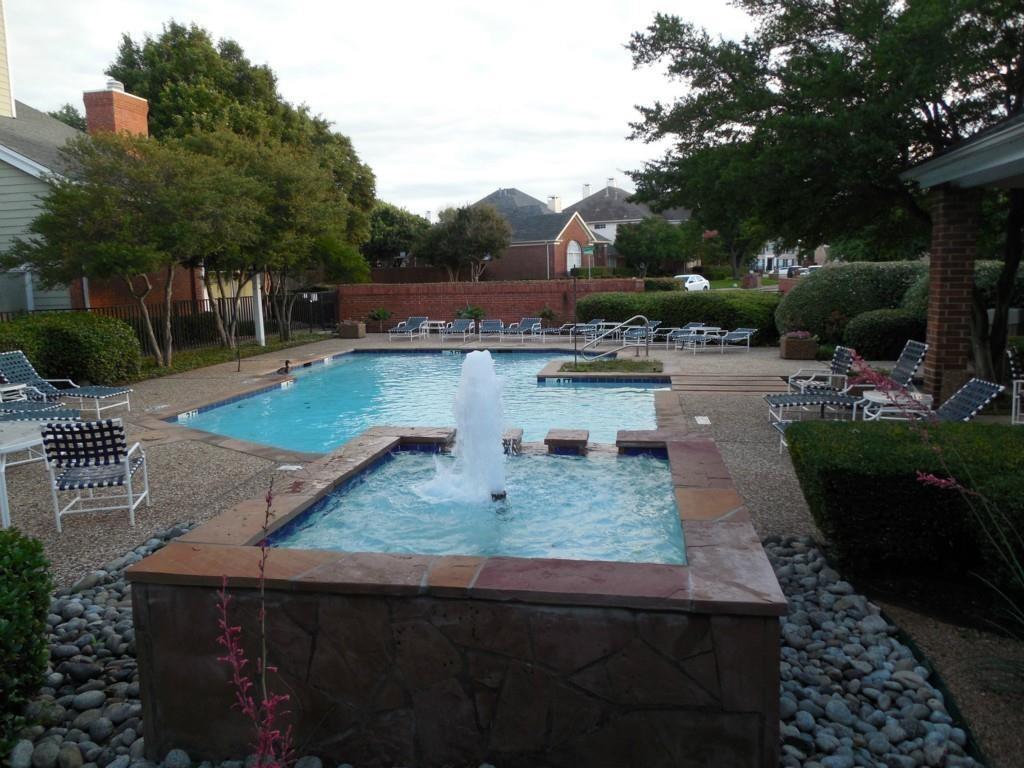 a view of a backyard and swimming pool