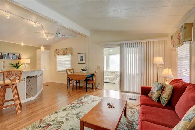 a living room with furniture wooden floor and a table