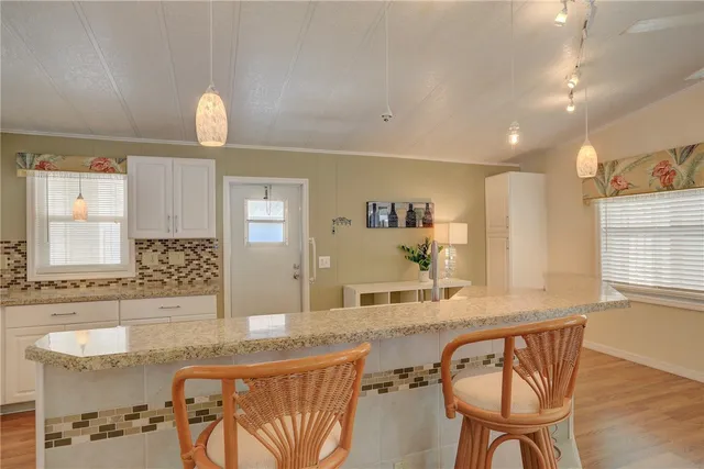 a bathroom with a granite countertop sink a mirror and a bathtub
