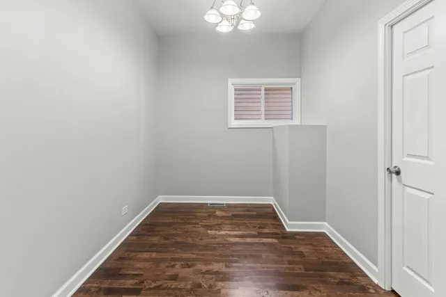a view of a room with wooden floor and white walls