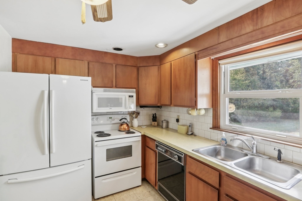 128 Harvard Road Stow, MA 01775 - Photo 12 of 36 a kitchen with a refrigerator sink and cabinets