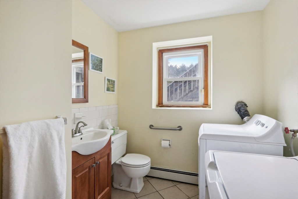 128 Harvard Road Stow, MA 01775 - Photo 21 of 36 a bathroom with a toilet sink and mirror