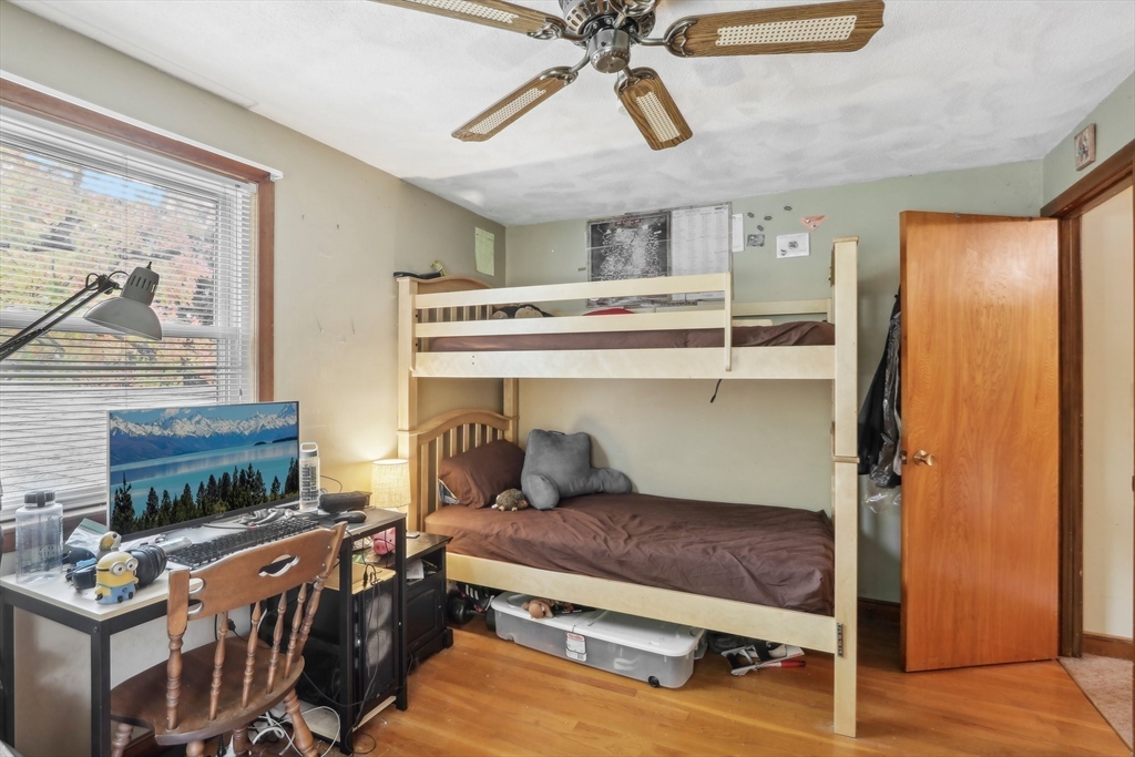 128 Harvard Road Stow, MA 01775 - Photo 25 of 36 a bedroom with furniture and flat screen tv